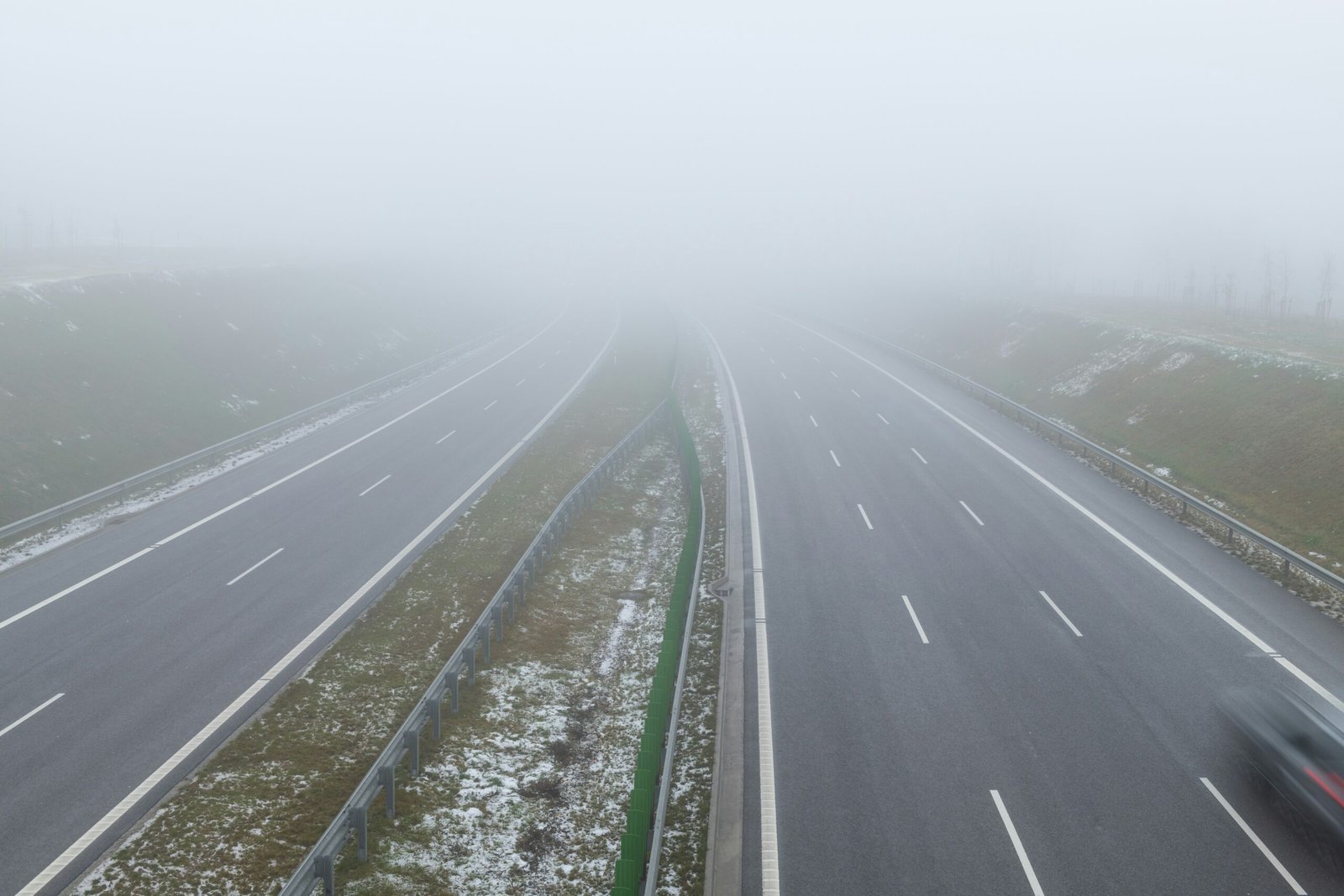 a road with fog on the side